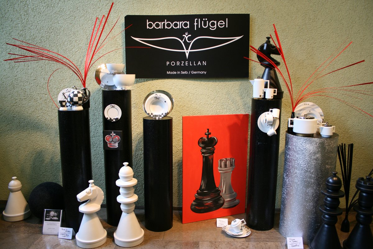 Ausstellungsbereich mit dem Firmenschild Barbara Flügel Porzellan und schwarz-weißen Objekten, 2009.